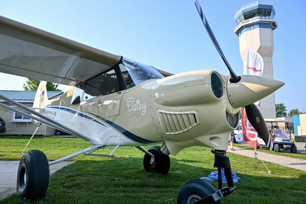 A CubCrafters NX Cub that will soon make its way to the Elephants, Rhinos, and People project in Namibia is on display at the Redbird Flight Simulations pavilion near the Wittman Regional Airport air traffic control tower during EAA AirVenture in Oshkosh, Wisconsin, July 20. The ERP.ngo organization founded by pilot Quintin Smith will invite FAA-certificated pilots to Africa to fly the NX Cub on anti-poaching missions. Photo by David Tulis.