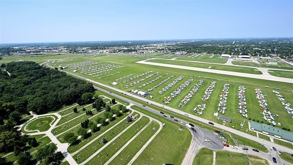 Aircraft are parked adjacent to each other as far as the eye can see in the North 40 area during EAA AirVenture Oshkosh 2025. Photo by David Tulis.